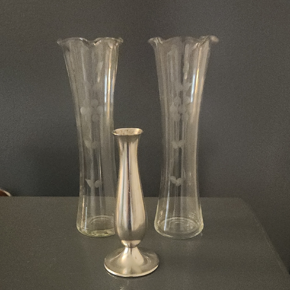 2 Elegant Glass Clear Vases and One Stainless Vase.